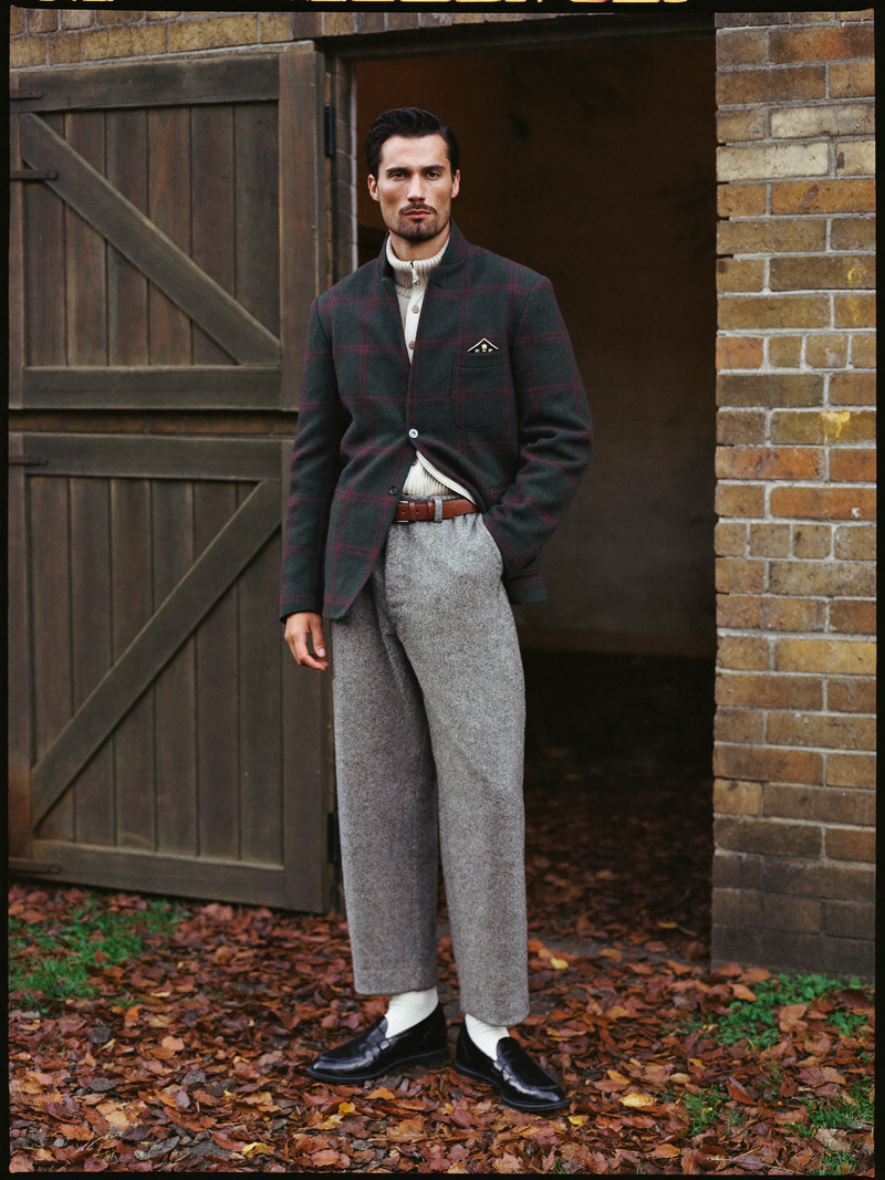 Man in tweed at countryside stable